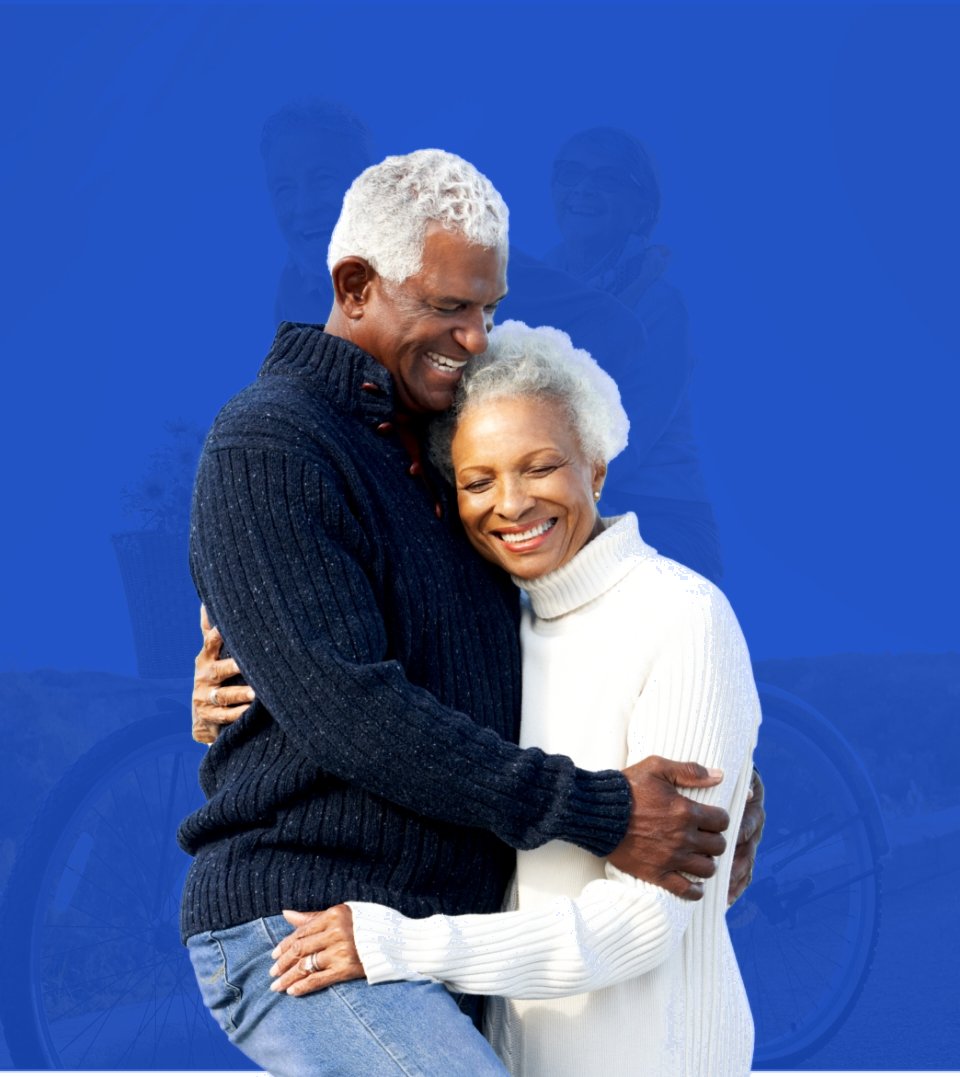 A smiling senior couple embracing, on a blue background